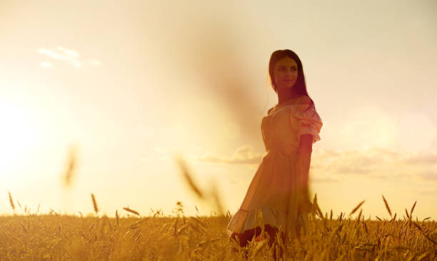 istock Woman in wheat field at sunset 1032686596