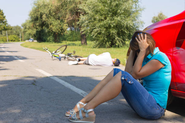 istock Cyclist lying on the road after an accident on a sunny day 1032693748