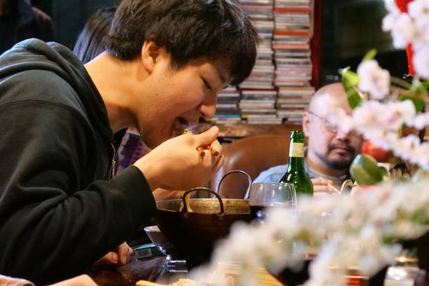 istock Japanese man eating noodle at bar 1032693902