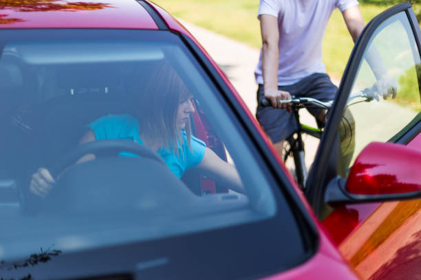 dangerous situation with cyclist and car - vehicle door imagens e fotografias de stock