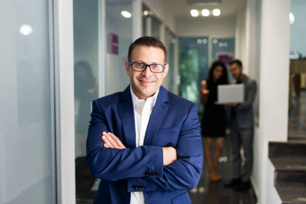 istock Middle-age business executive crossing arms and smiling at camera 1032703128