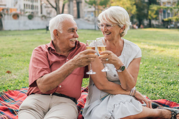 istock Smiling old couple drinking wine outdoors 1032703630