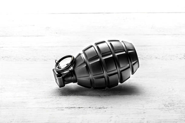 Hand grenade isolated on white background. Close-up. Weapon of war. Fragmentation grenade detail. Military training concept. Explosive weapon.