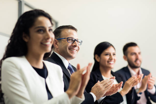 istock Cheerful business executives clapping and smiling 1032707432