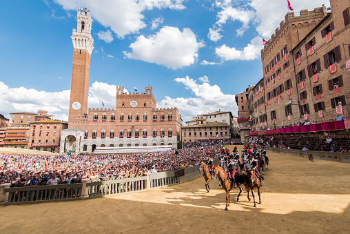 Parade with people wearing traditional and historical clothes before the race at Siena city, Italy, during the August 16th, 2018 The 