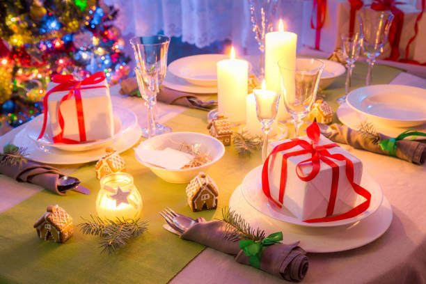 istock Christmas table setting with candles and gifts 1032708372