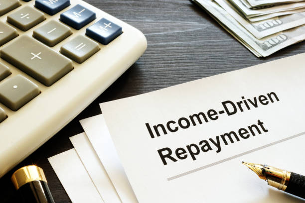 istock Income Driven Repayment. Papers, calculator and money. 1032709540
