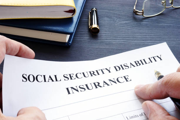 istock Man is holding Social Security Disability Insurance SSDI policy. 1032711518