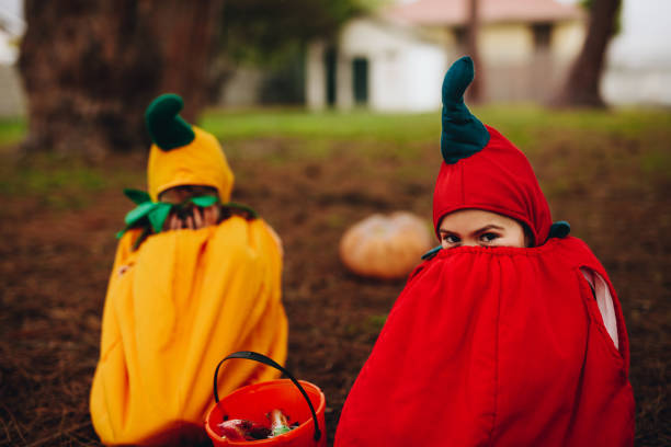 istock Twin sisters tricking outdoors on halloween 1032712926