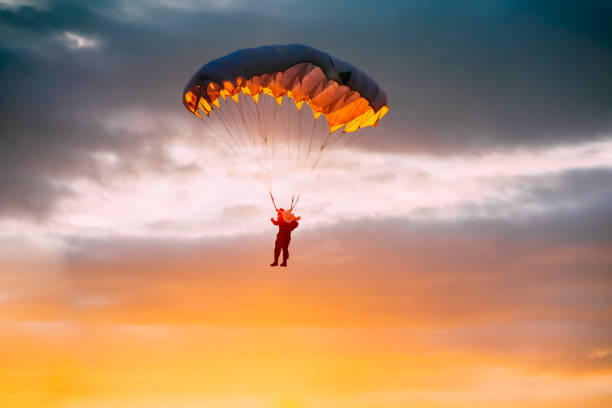 istock Skydiver On Colorful Parachute In Sunny Sky 1032713620