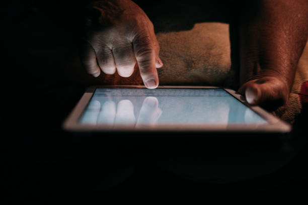istock Senior Woman Looking Her Photo On Tablet 1032721008
