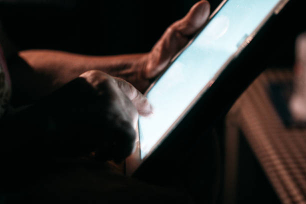 istock Senior Woman Looking Her Photo On Tablet 1032721108