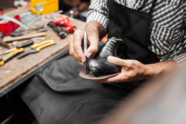 istock Shoe maker measuring sole of the shoe 1032721954