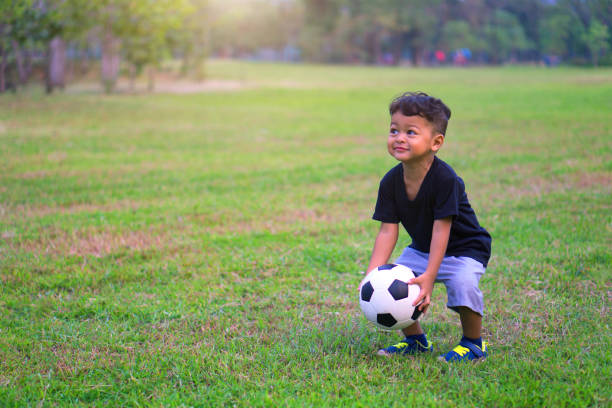 istock Boy Playing With Ball On Field 1032725692
