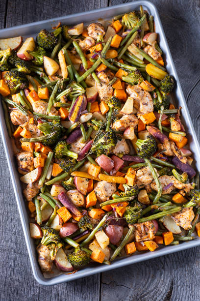 Sheet Pan Chicken Sheet Pan Chicken Dinner with Red Potatoes, Green Beans, Sweet Potatoes, Rainbow Carrots, Garlic, Onion, Broccoli and Thyme. baking sheet stock pictures, royalty-free photos & images