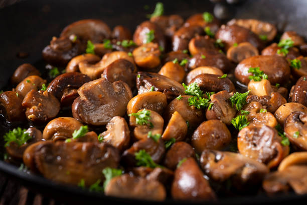Skillet Mushrooms Mushrooms Sautéed In a Carbon Steel Skillet side dish stock pictures, royalty-free photos & images
