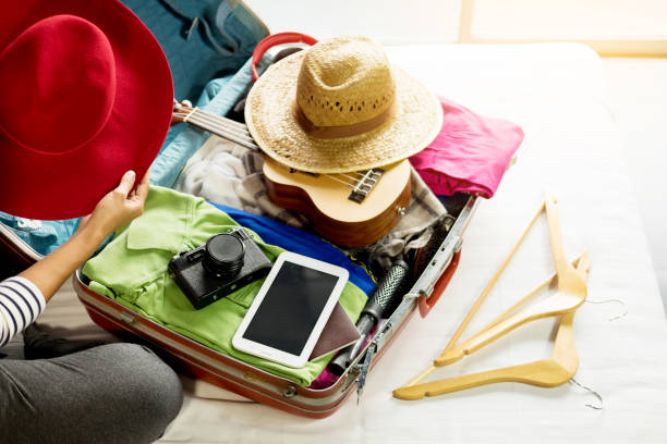 istock High Angle View Of Woman Packing Suitcase On Bed 1032729114