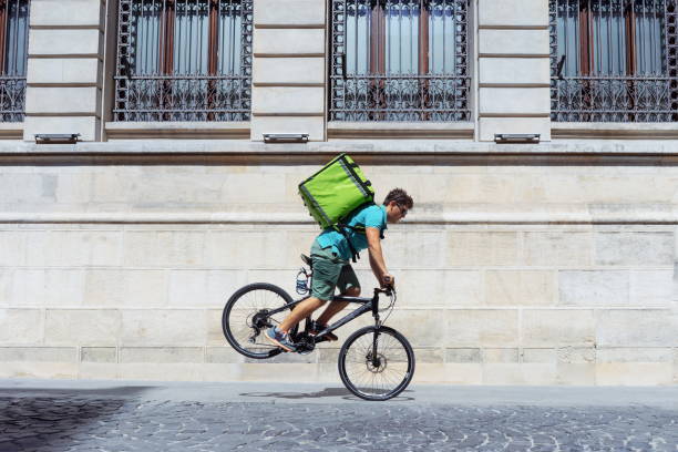 istock Young Man Performing Stunt While Riding Bicycle On Street 1032729160