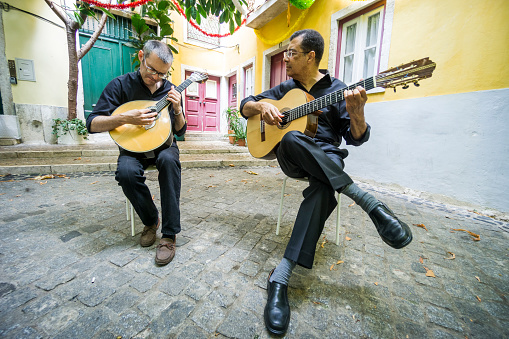 Two fado guitarists with acoustic and portuguese guitars in Alfama, Lisbon, Portugal
