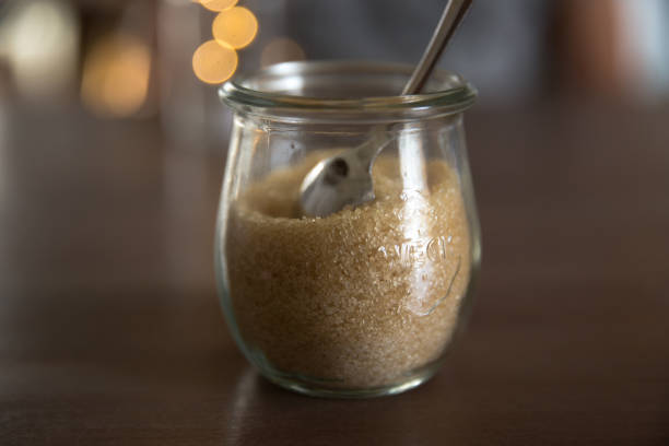 istock Brown sugar in glass jar on wooden table 1032732492
