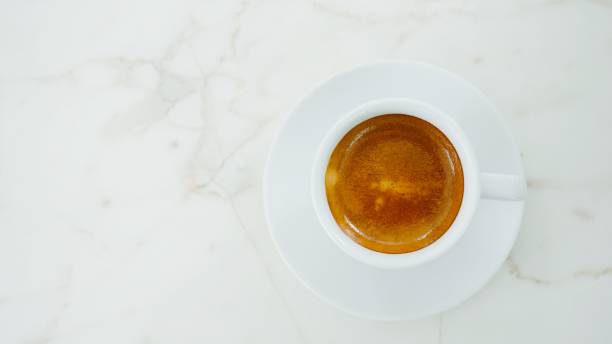 istock Top view of hot espresso coffee cup on white table 1032732524