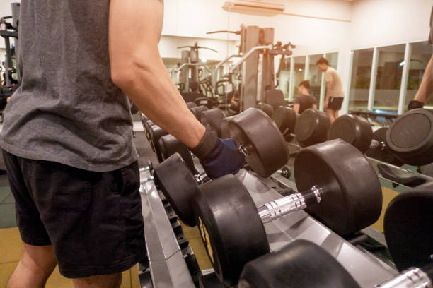 istock Human Hand holding dumbbell in gym 1032734630