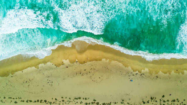 istock Waves approaching the coast at Tunquen beach turquoise waters creating impressive forms in order to get to the coastline and crash the sand from an aerial point of view from the drone just amazing 1032740230