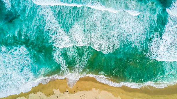 istock Waves approaching the coast at Tunquen beach turquoise waters creating impressive forms in order to get to the coastline and crash the sand from an aerial point of view from the drone just amazing 1032740246