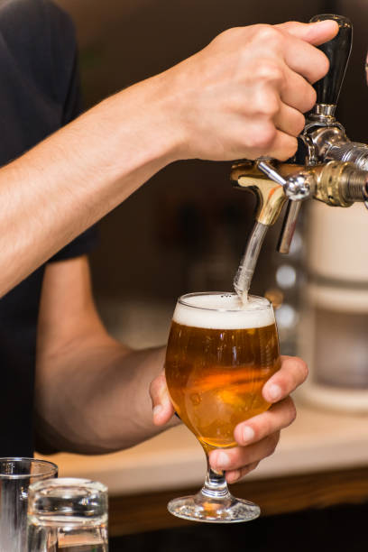 istock The barman pours beer in a glass 1032740302