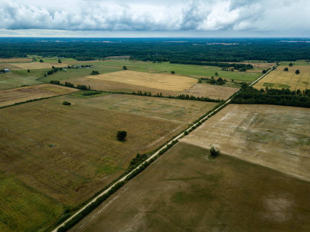 istock drone image. aerial view of rural area with fields and forests under dramatic storm clouds forming 1032740914