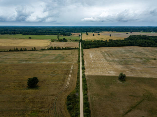 istock drone image. aerial view of rural area with fields and forests under dramatic storm clouds forming 1032741008