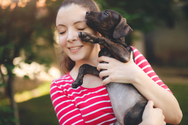 istock Young caucasian girl holding puppy 1032748512