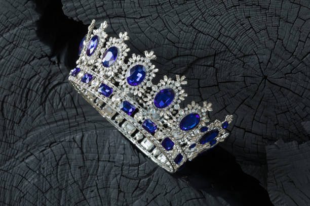 istock silver royal crown on a black wooden background 1032754154