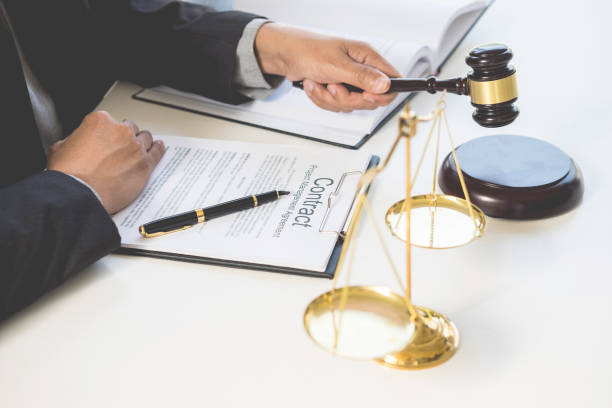 istock Midsection Of Judge Holding Gavel At Table In Courthouse 1032771082