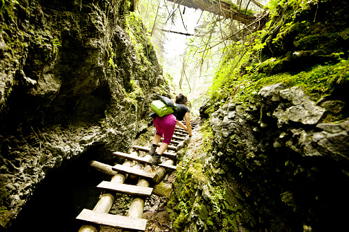 Woman Climbing A Ladder In Slovensky Raj (Slovak Paradise National Park), Slovakia