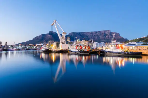 Sunrise at the  Victoria and Alfred Waterfront harbour in Cape Town, with Table Mountain in the background.