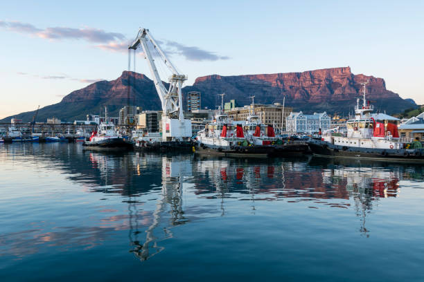 Sunrise at the  Victoria and Alfred Waterfront harbour in Cape Town, with Table Mountain in the background.