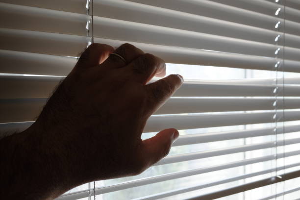 istock spying from behind the curtain 1032782230