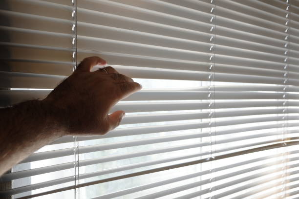 istock spying from behind the curtain 1032782232
