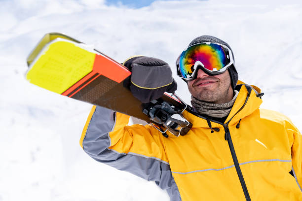istock Portrait of a happy man snowboarding 1032803318