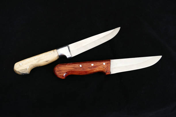 istock sharp turkish knives with wooden handle on black ground, 1032803658