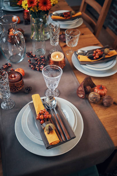 istock Decorated Table for Thanksgiving Dinner with Candles, Pumpkins, Leafs and Nuts 1032820108