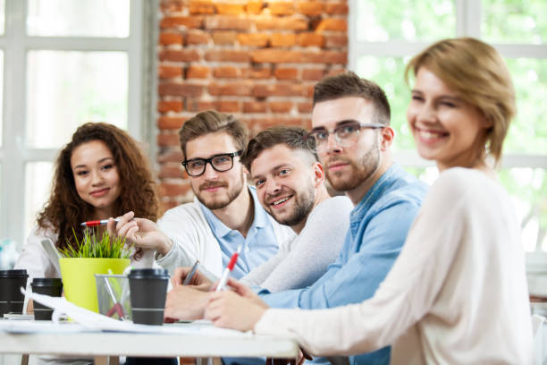 istock Group of young multiracial people working in modern light office. Businessmen at work during meeting. 1032822830