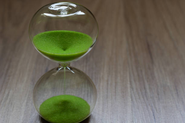 istock Hourglass with green sand, life time passing concept 1032823374