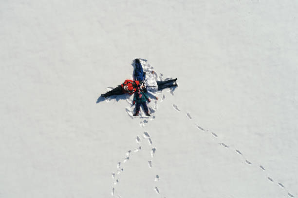 istock Family lying on the snow at sunny day 1032841926