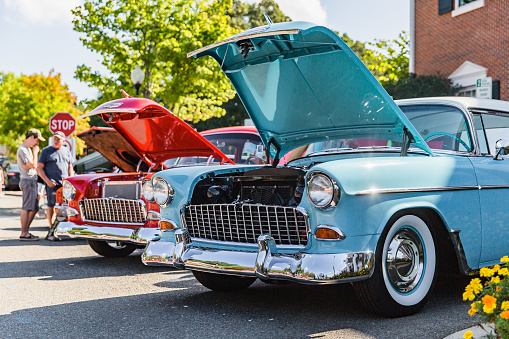 Matthews, North Carolina -  September 3, 2018: Visitors admire vintage 1950s era Chevrolet and Ford cars parked on display at the Matthews Auto Reunion