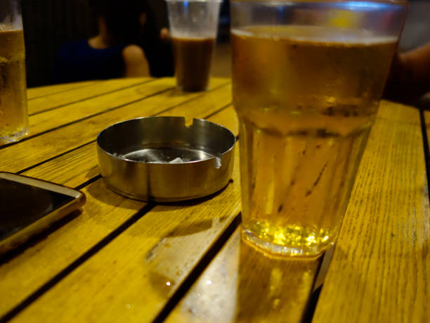istock beer, cigarettes and telephone on wooden table 1032848244