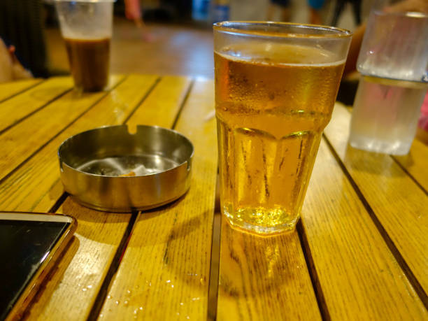 istock beer, cigarettes and telephone on wooden table 1032848442