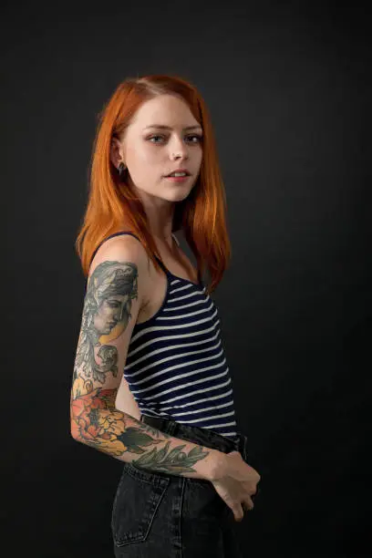 studio portrait of a tattoo artist on a black background