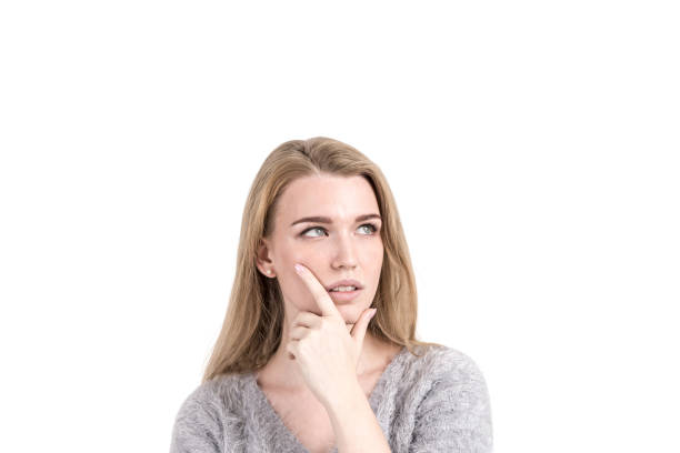 istock Pensive blonde woman daydreaming, isolated 1032851090